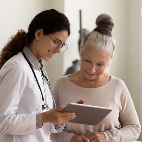 Physician Showing Hispanic Woman Her Test Results