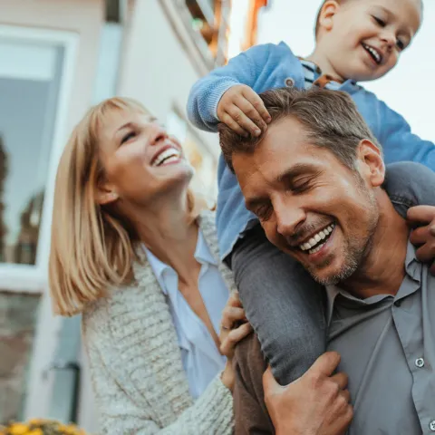 Mother, Father and Child Playing Outdoors