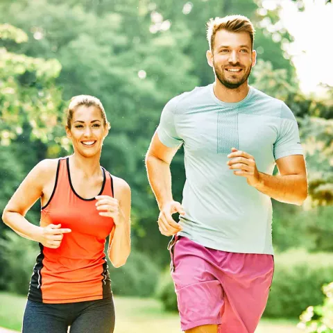 A young man and woman running.