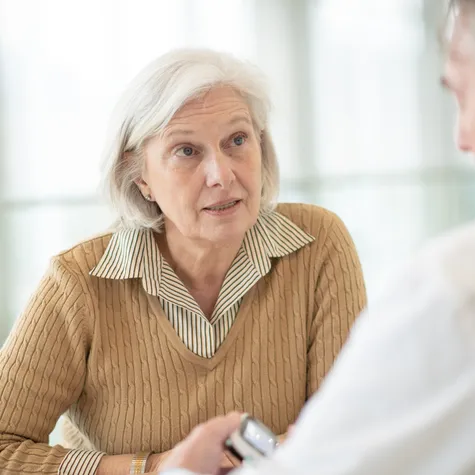 senior woman speaking with doctor