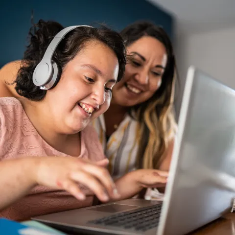 Autistic Child With Headphones on Using Computer