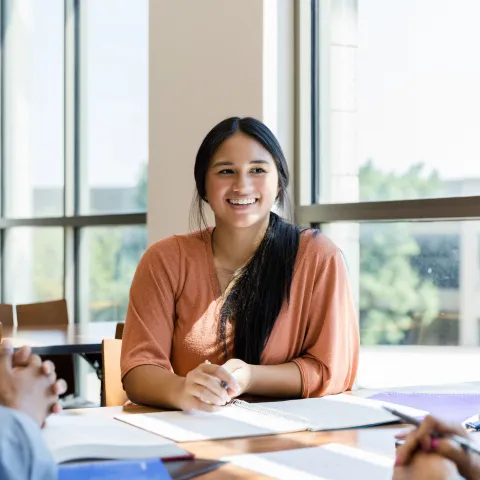 Hispanic Girl Smiling at Other Students