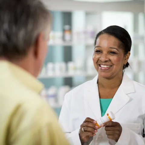 Pharmacist Smiling at Customer