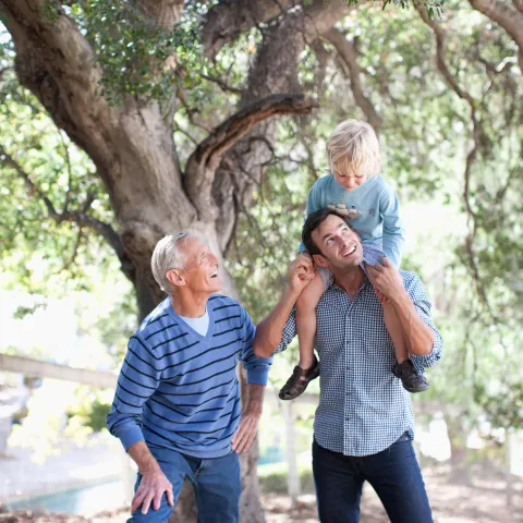 Father, son and grandfather spending time together outside.