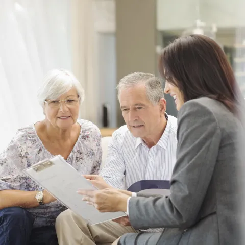 Two older patients talking to a transplant coordinator