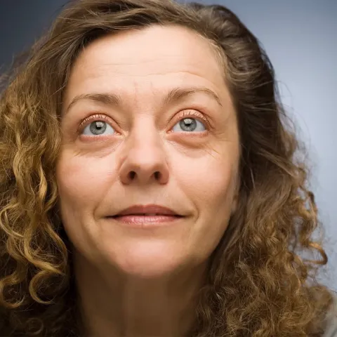 Woman looking up smiling.