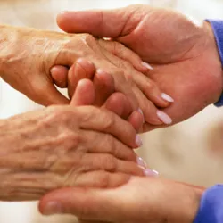 Two people hold hands