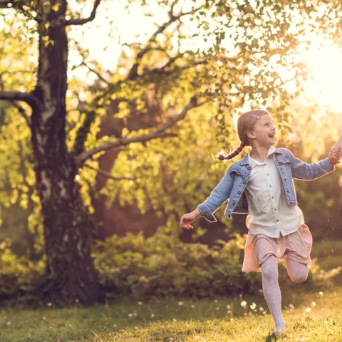 Mother and Child Running in Park