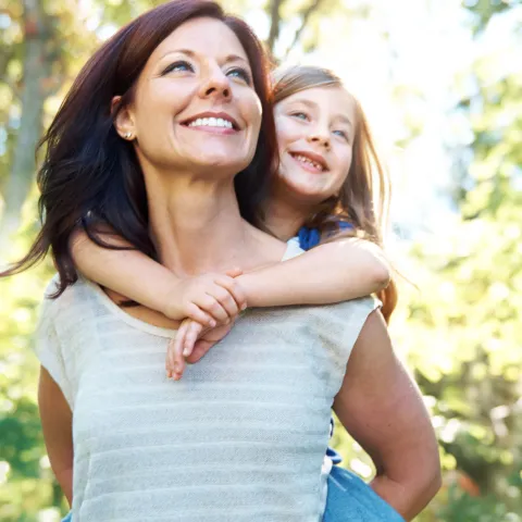 Mother holding daughter from behind
