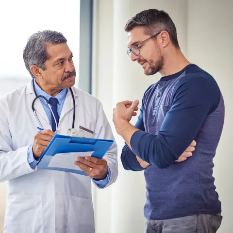 Adult White Man Discusses His Condition With A Doctor