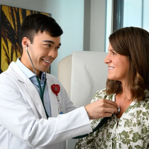 Doctor checking patient's heart.