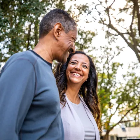 Couple walking outdoors in park