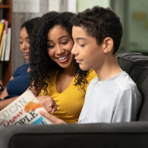 Son Showing Mom Page in Book