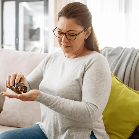 A woman taking her medication.