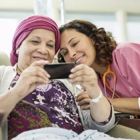 Female Volunteer spending time with female cancer patient