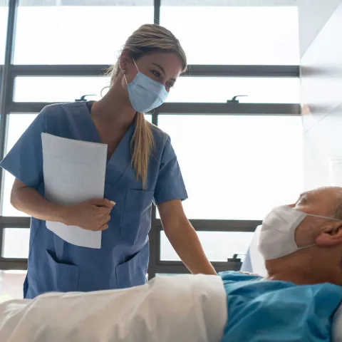 Nurse Checks on an Patient in His Hospital Room.