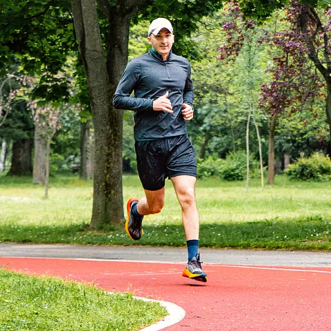 Man running outdoors at park.