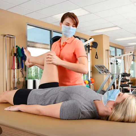 A woman getting physical therapy done by a female specialist