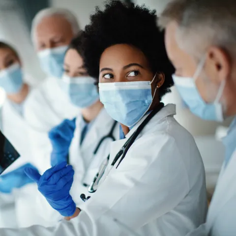 Doctors reviewing scans for patient with other doctors
