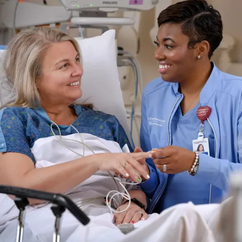 UChicago Medicine AdventHealth Nurse Helping Patient in Hospital