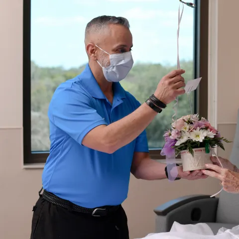 Volunteer giving patient a gift
