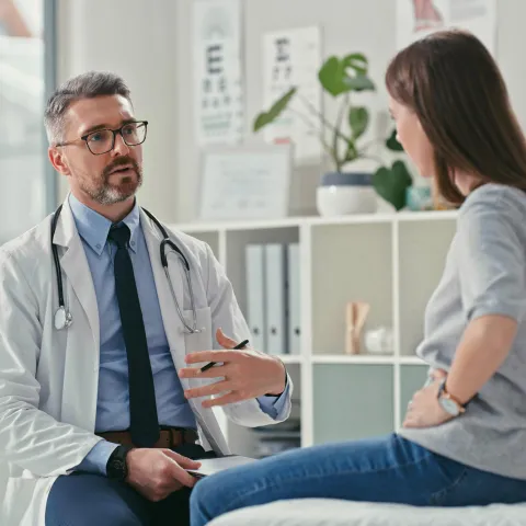 Female patient talking to male doctor