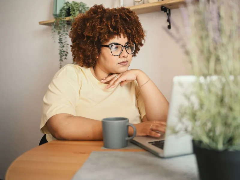 Woman on Laptop Checking Bills