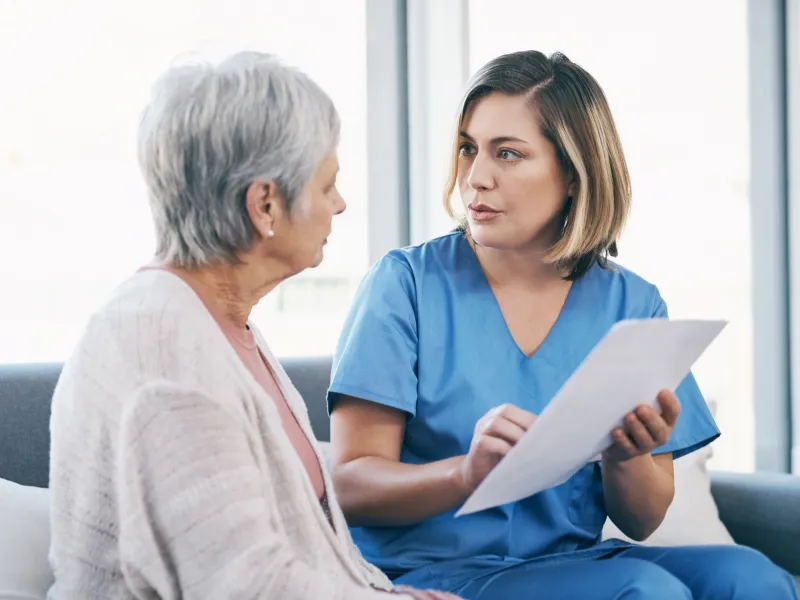 A Physician Goes Over a Chart with a Senior Patient.