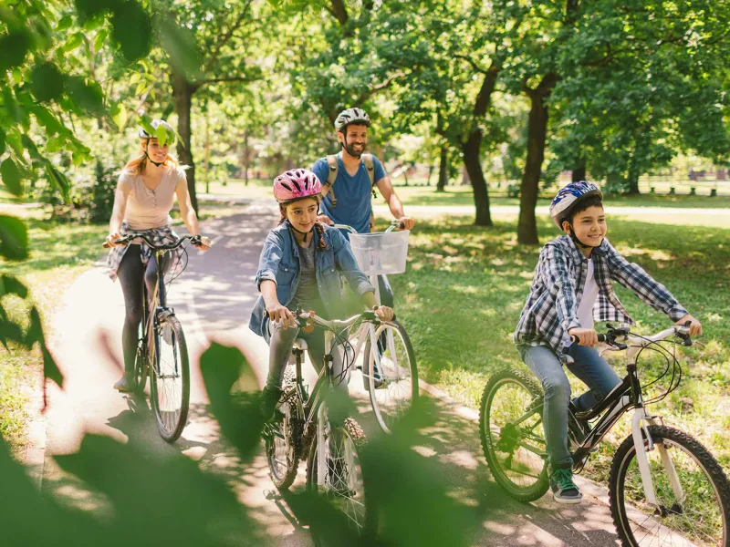 A family on a bike ride at a park