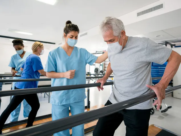  Nurse Helping Patient with Rehabilitation Exercise