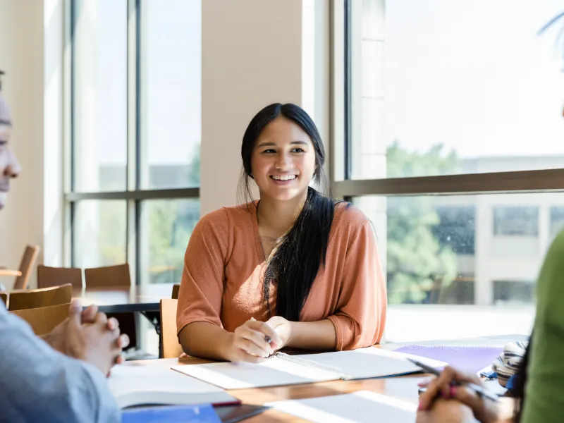 Hispanic Girl Smiling at Other Students