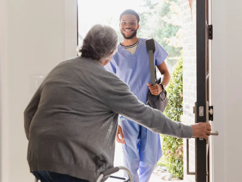 Nurse visiting patient at home.
