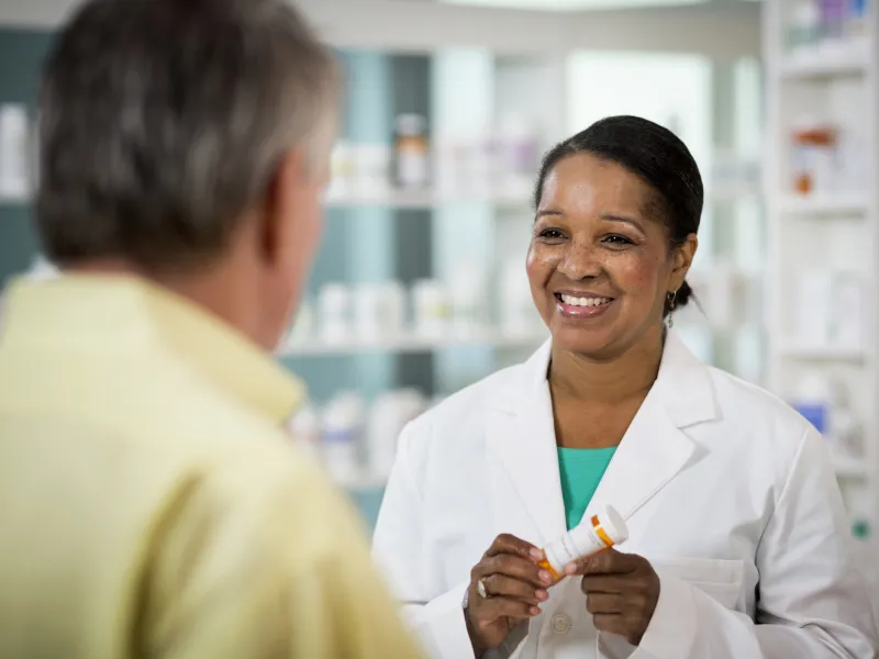 Pharmacist Smiling at Customer