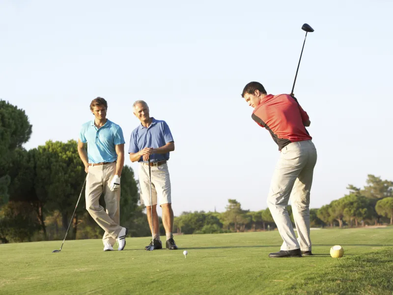 Three men golfing.