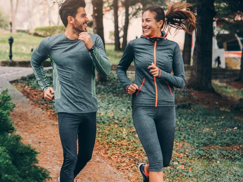 Two Friends Jogging in Park