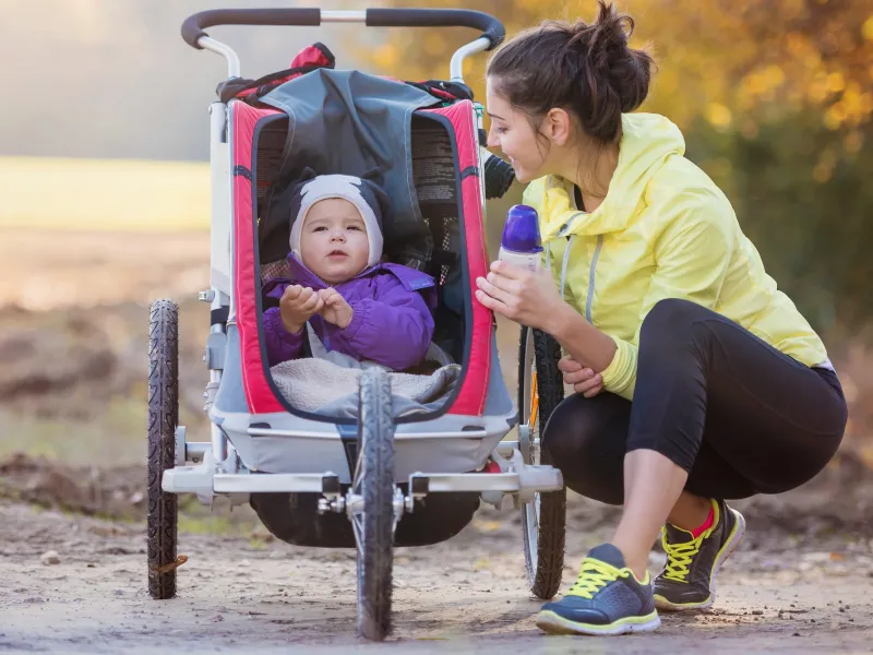 Mom Walking in Park With Baby in Stroller