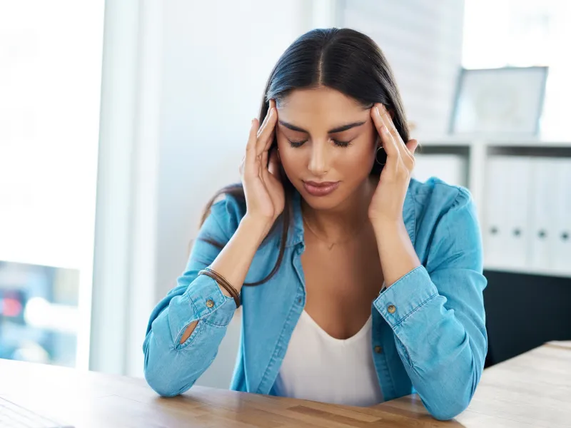 A woman applying a physical technique on her temples