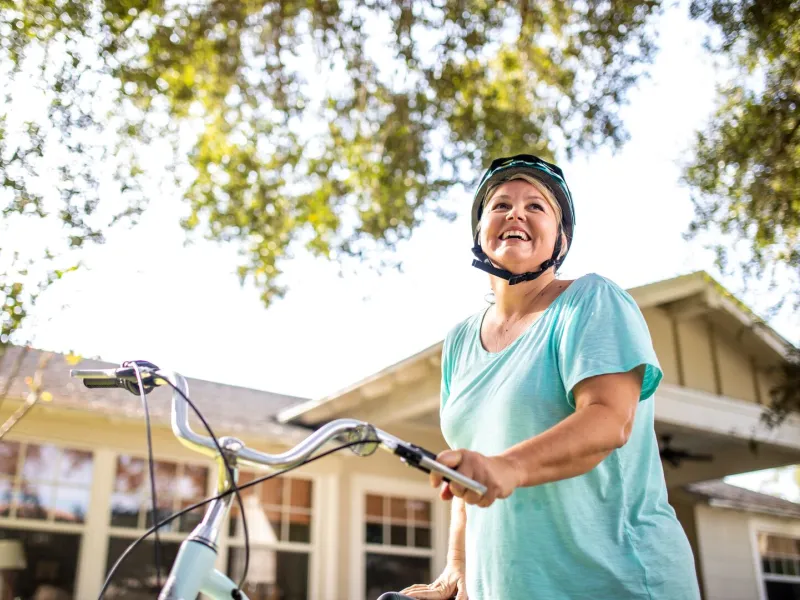 Woman with bike with helmet on