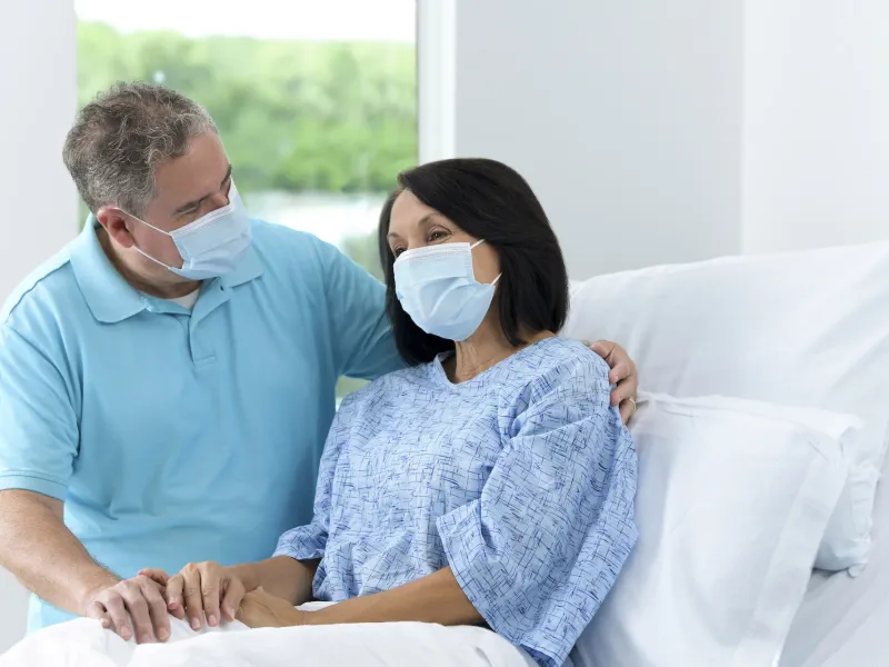 Patient with Family visitor in hospital bed