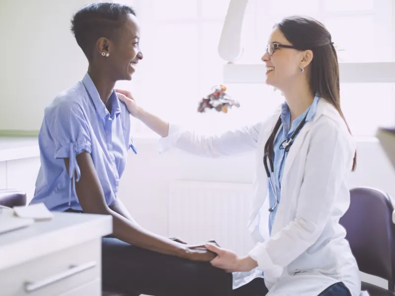 Woman getting her checkup with Primary Care Doctor