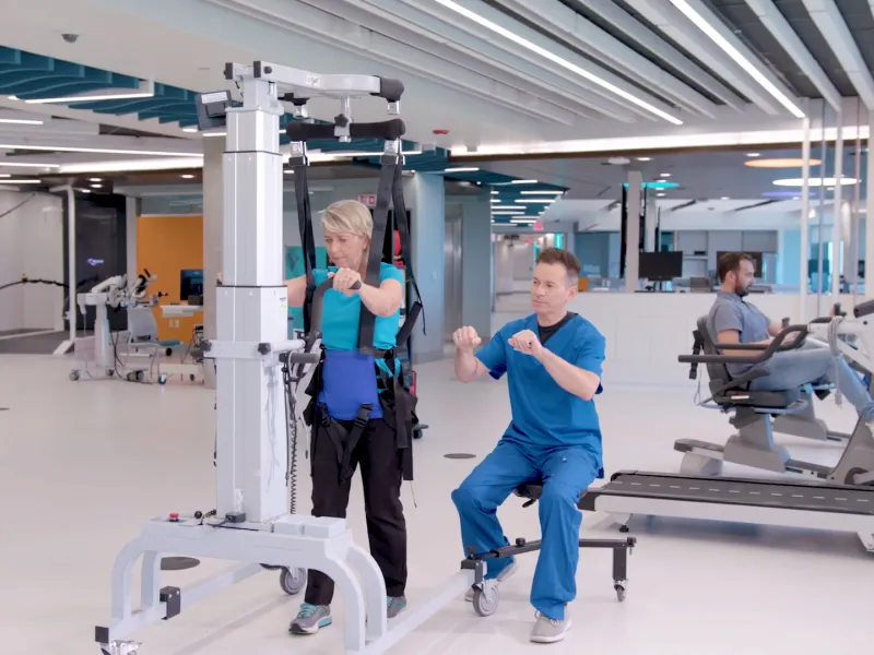 A Therapist Helps a Patient Through a Physical Therapy Session.