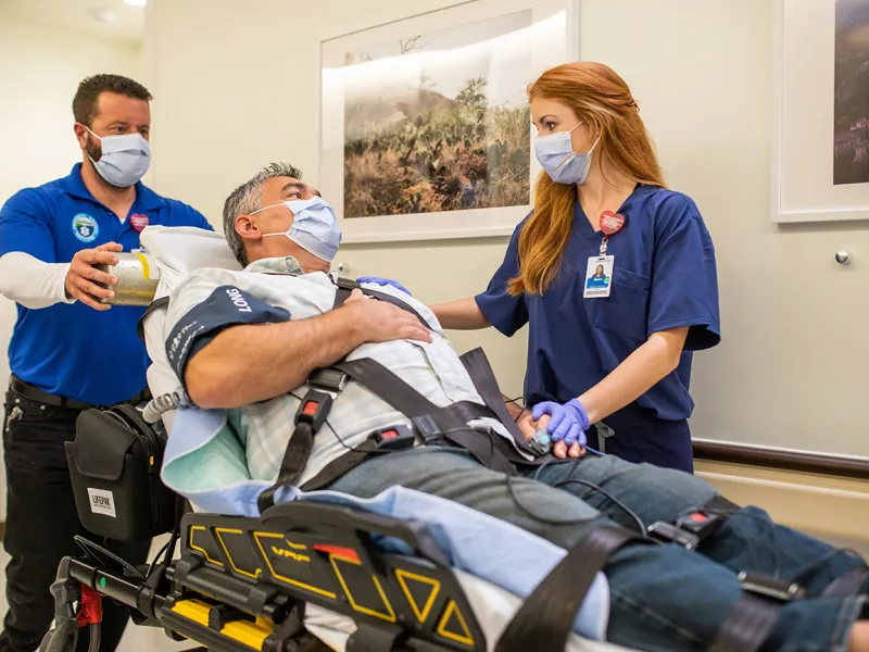 Patient in Stretcher Being Taken into ER Room