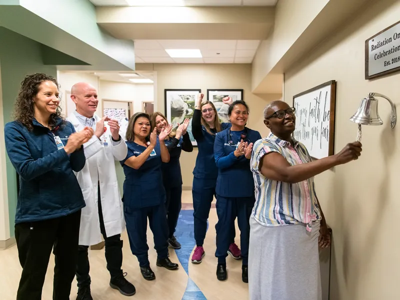 Women Ringing Radiation Oncology Bell