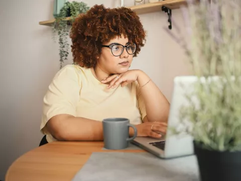 Woman on Laptop Checking Bills