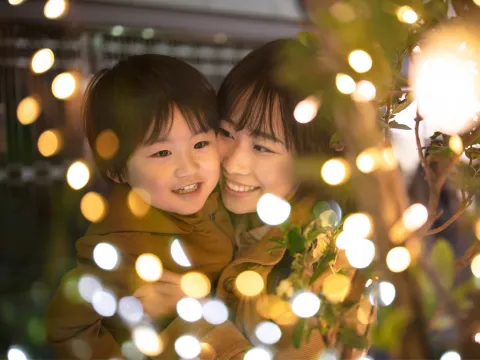 A Mother and Son Enjoy Christmas Lights Outside in the Winter Weather