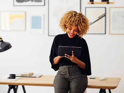 A African American woman using a tablet at her office