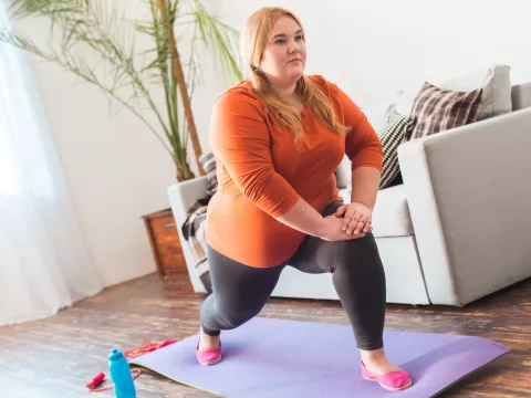 A Woman Stretches During Yoga in Her Home