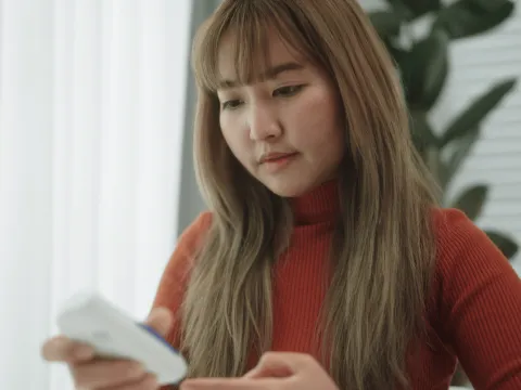 A Woman Checks Her Glucose Monitor