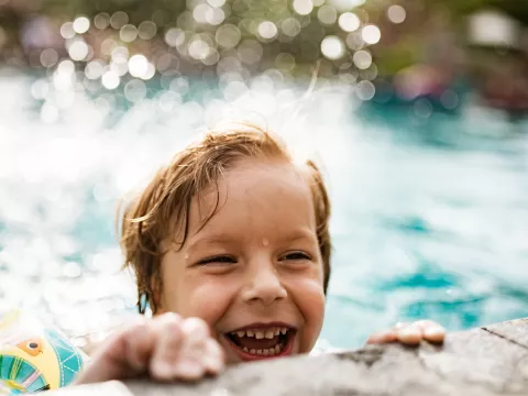 Boy swimming in pool.