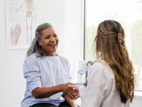 A Patient Greets a Provider in an Exam Room